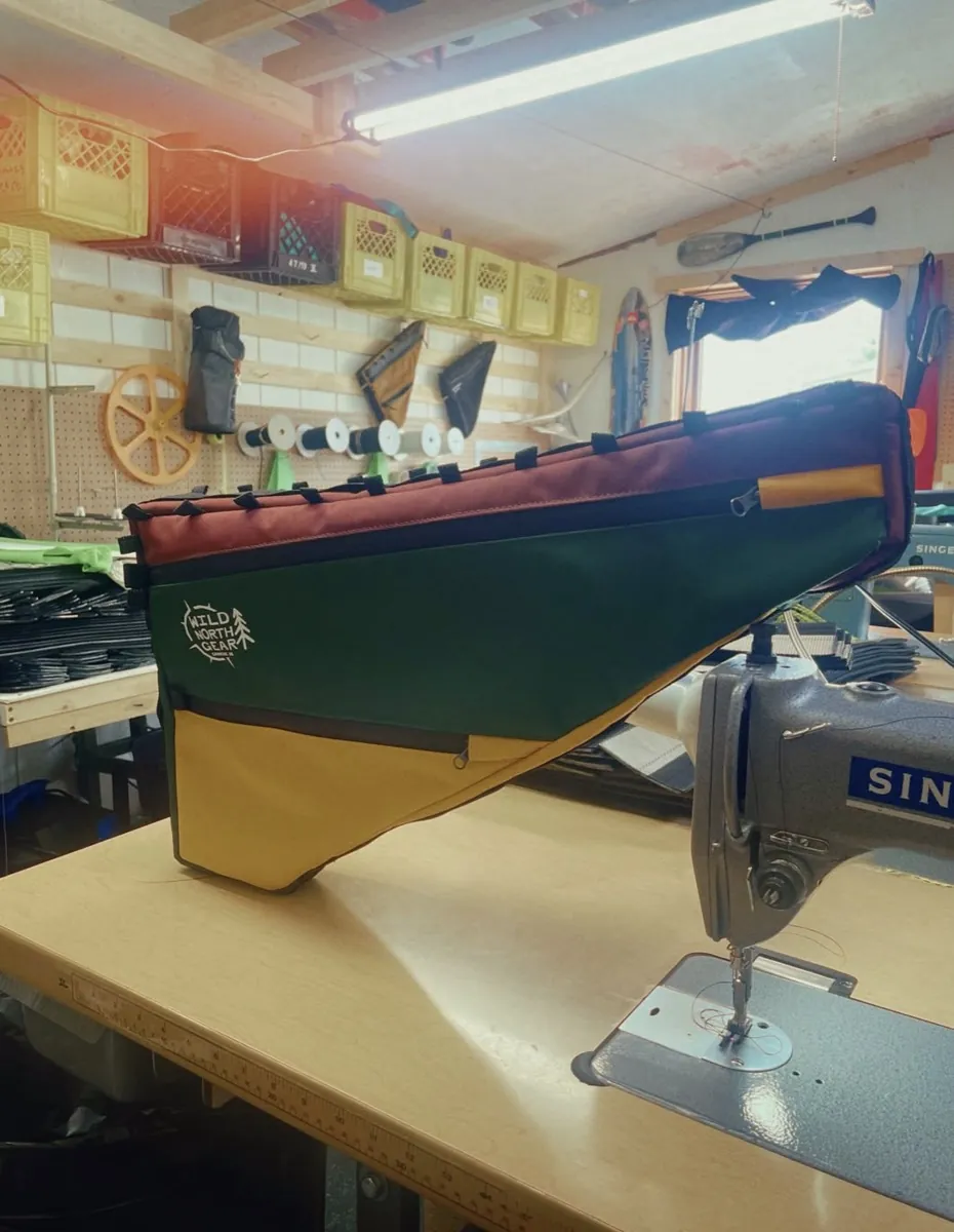 A teal and gold frame bag on the sewing machine in Steve's workshop