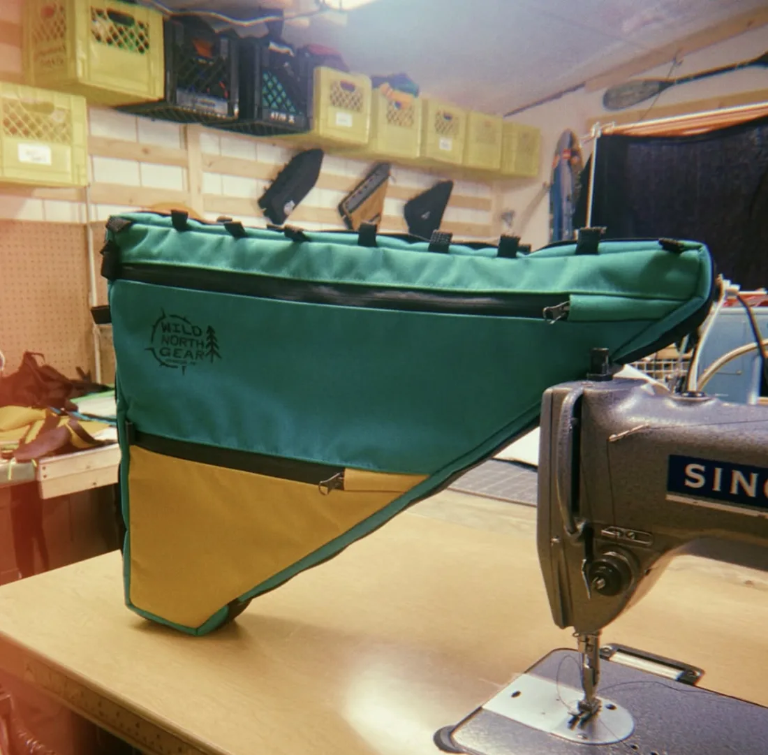 A teal and gold frame bag on the sewing machine in Steve’s workshop